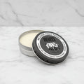 Reuzel pomade tin with open lid on a white background