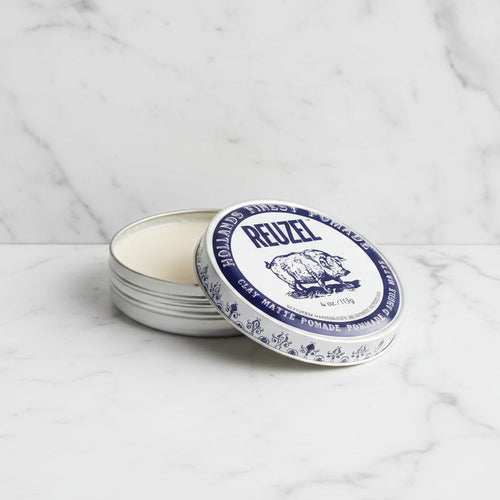 Reuzel pomade tin with blue label on a white background