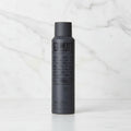 Black hair spray bottle with text on a white background
