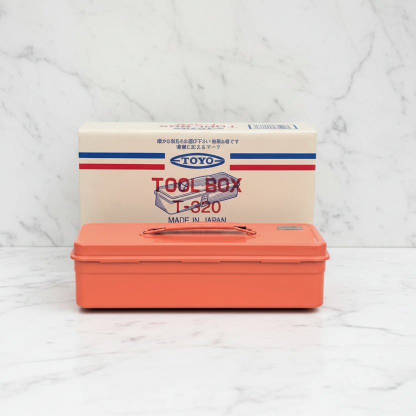 Orange toolbox with a white box featuring 'Toyo' branding on a light gray surface.