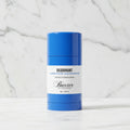 Blue deodorant stick with natural elements on a white background