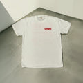 White t-shirt with red logo on a gray surface