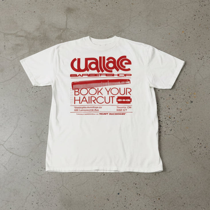 White t-shirt with red text and graphics on a concrete surface